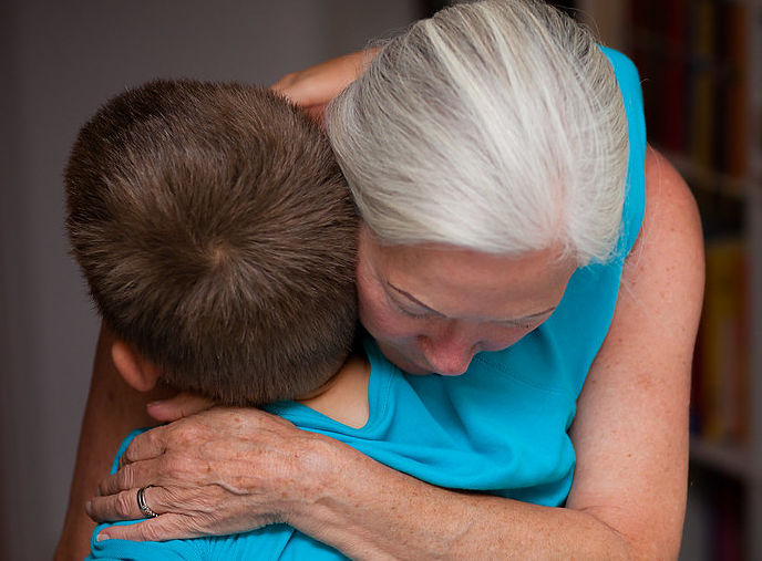 Child and caregiver hugging